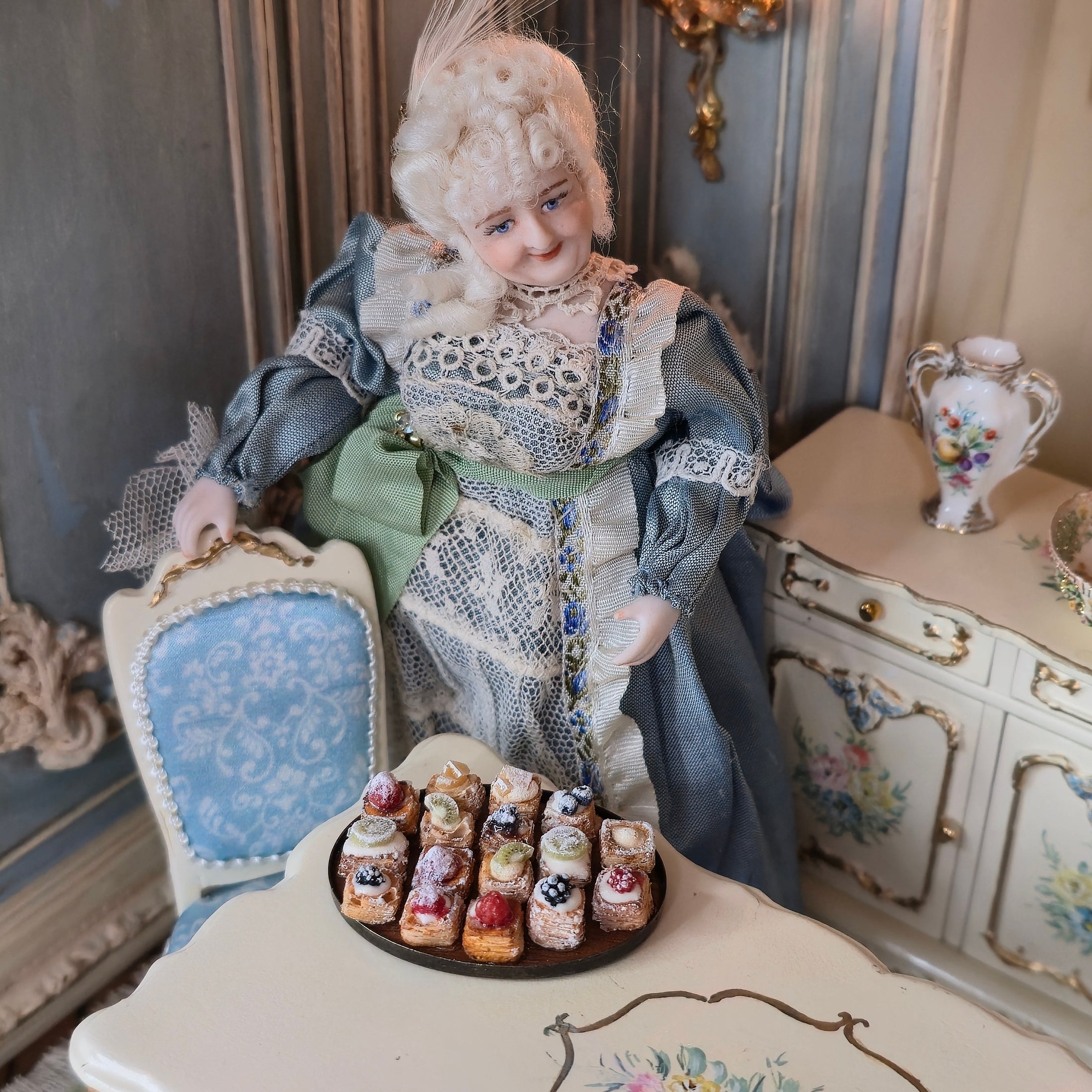 miniature in ornate room with dollhouse doll