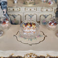 Load image into Gallery viewer, Miniature pastry under a dome on a decorative table with floral patterns
