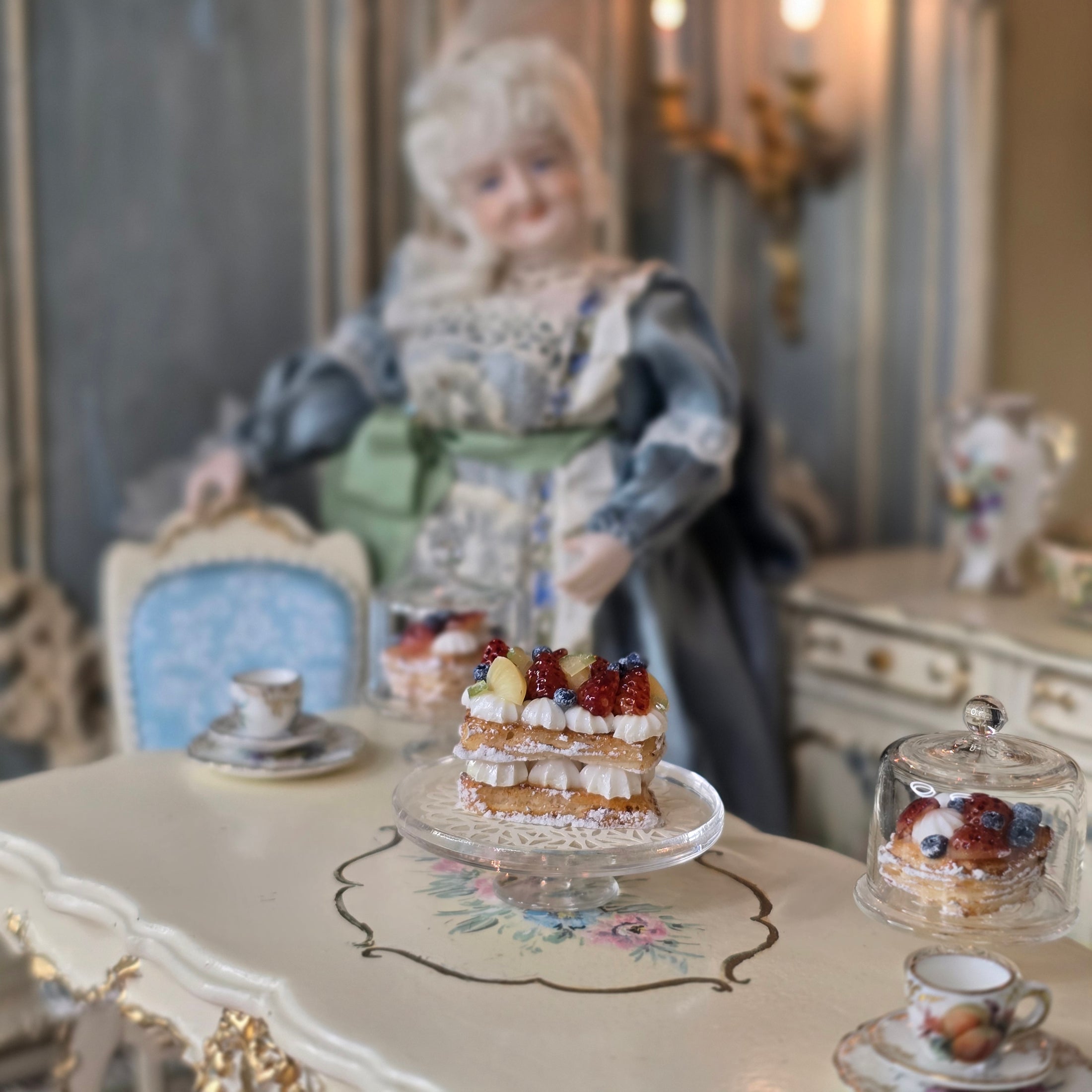 Decorative cake stand with miniature pastries on a blurred background