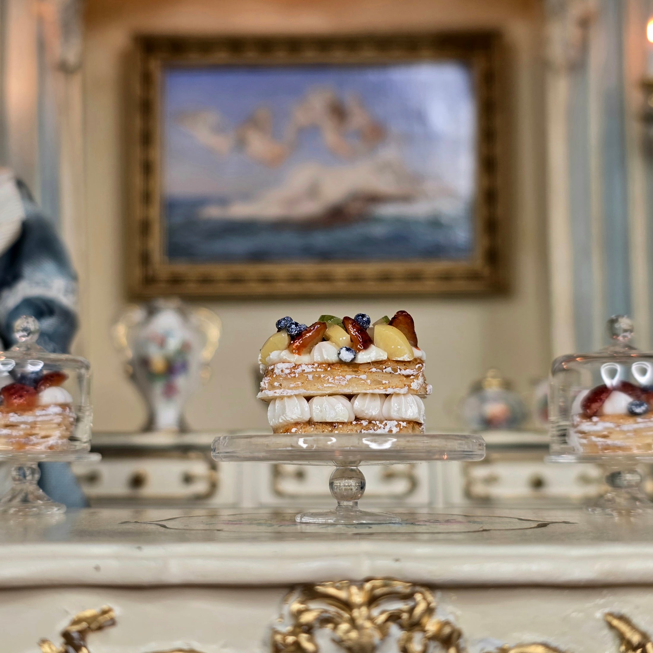 miniature dessert on a cake stand with a decorative interior background