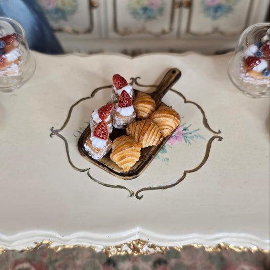 Miniature pastries on a wood tray