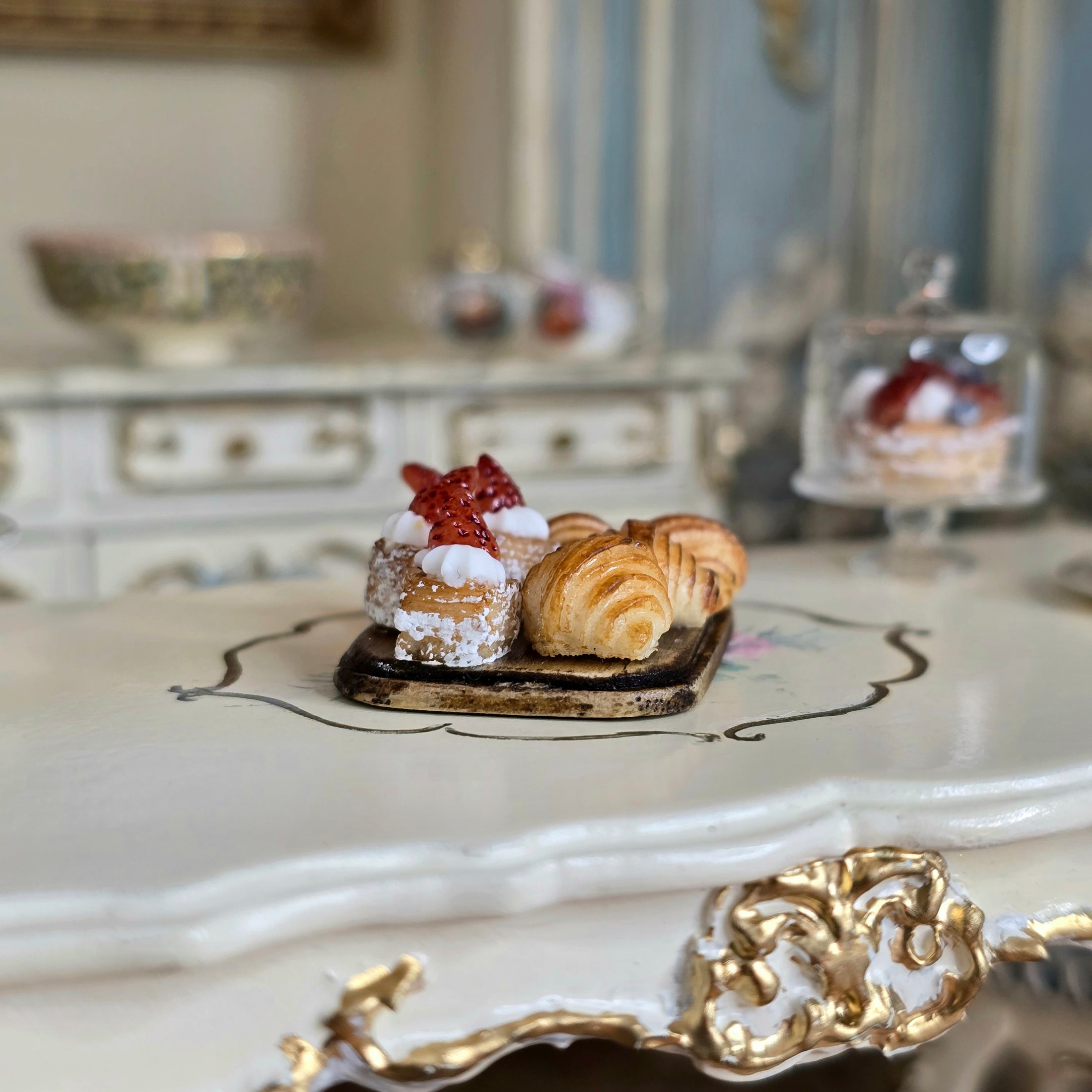 Miniature pastries on an ornate surface with a blurred background