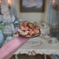 Load image into Gallery viewer, Miniature pastries on wooden serving board, balanced on a finger
