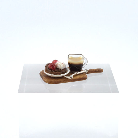 Café au lait with a dessert on a wooden tray on a white surface