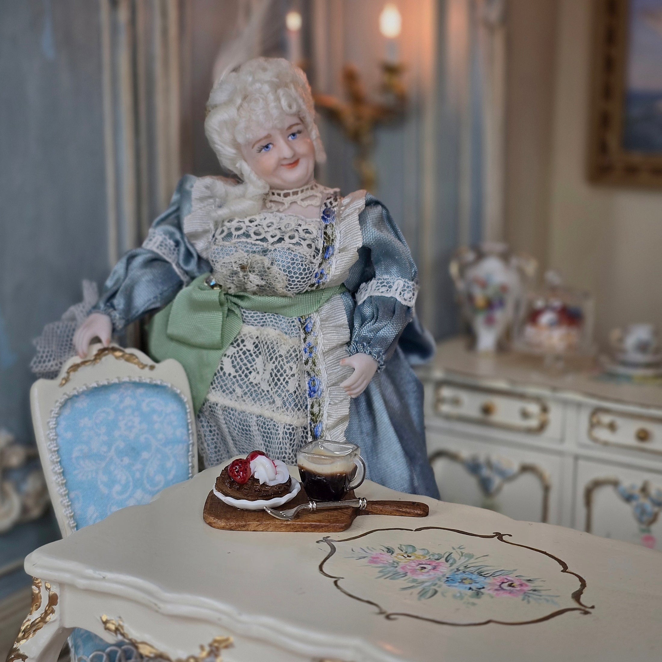 Porcelain doll in a vintage setting with a table and chair.