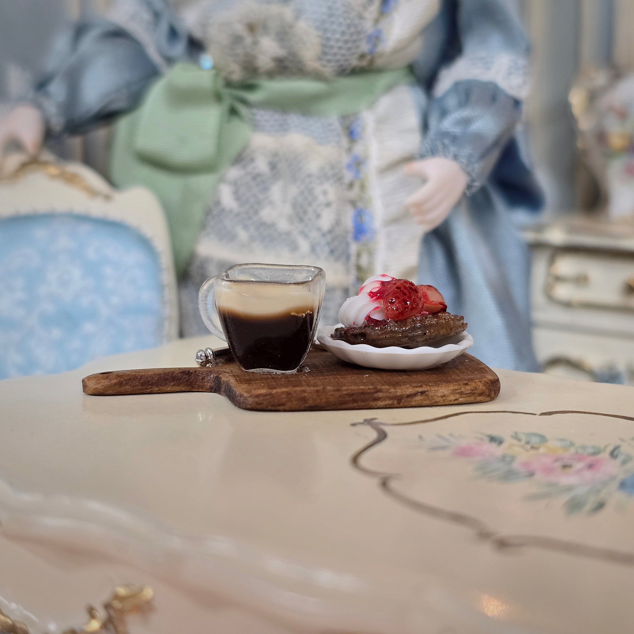Cup of coffee and dessert on a wooden board with decorative background