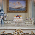 Load image into Gallery viewer, Fruit tart on a glass stand with a decorative background
