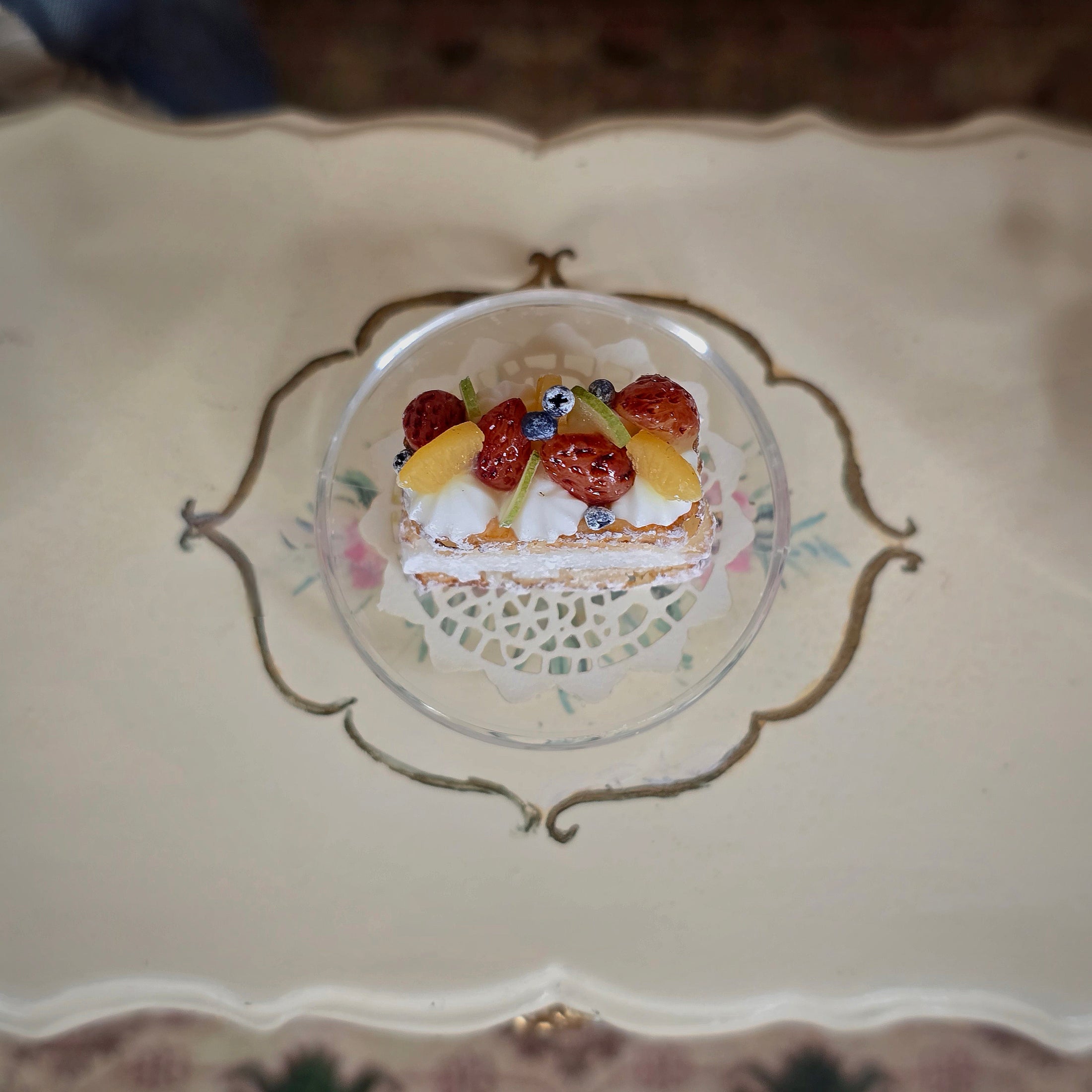 Small cake with fruit on a decorative plate