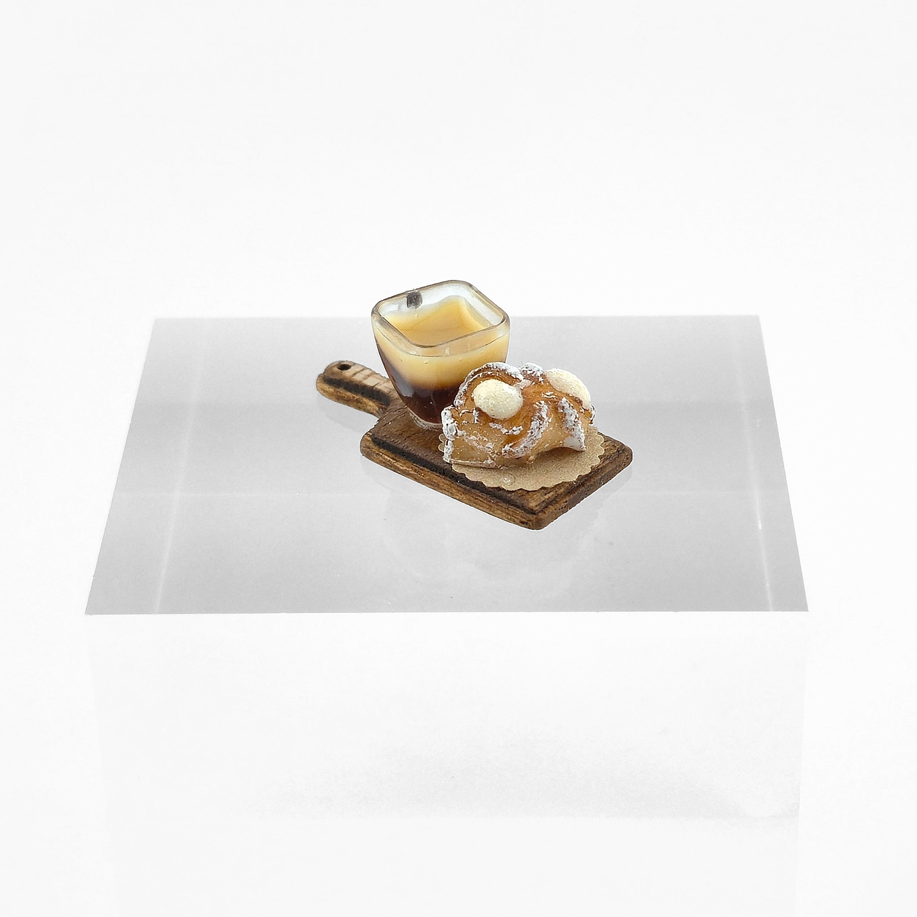Dessert with a pastry and coffee on a white plate