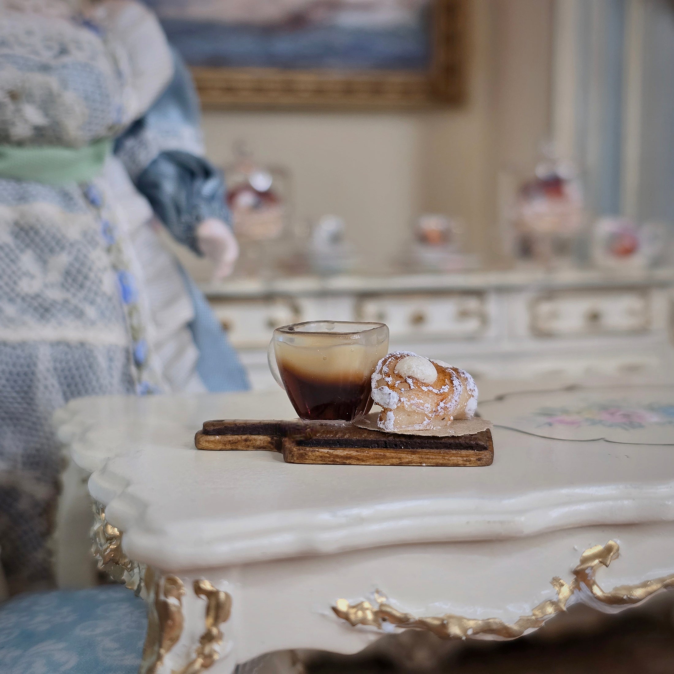 Cup of coffee and pastry on a marble surface with decorative elements