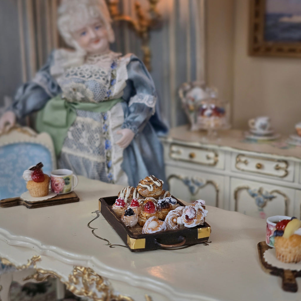pastry tray in decorated room with miniature doll
