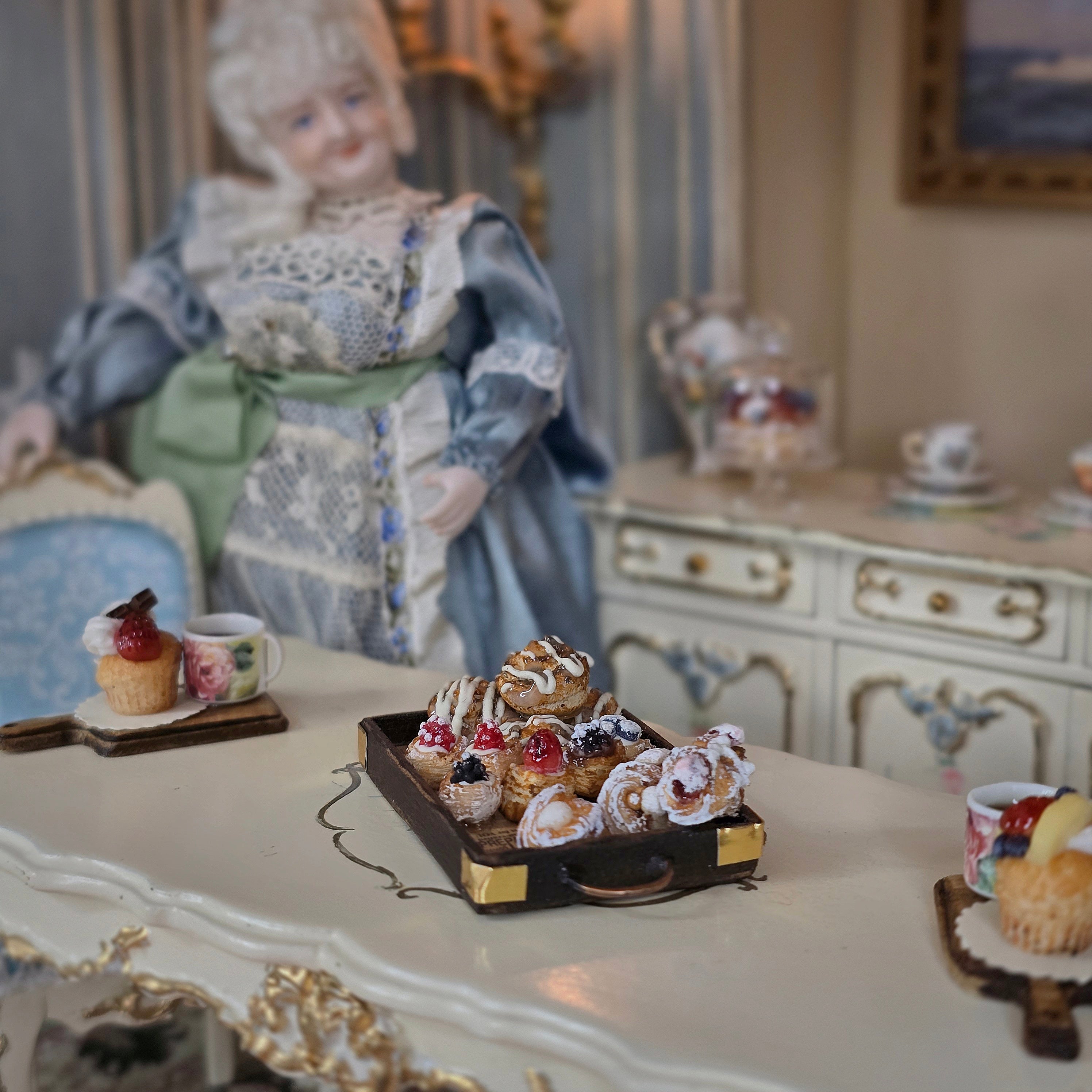 pastry tray in decorated room with miniature doll
