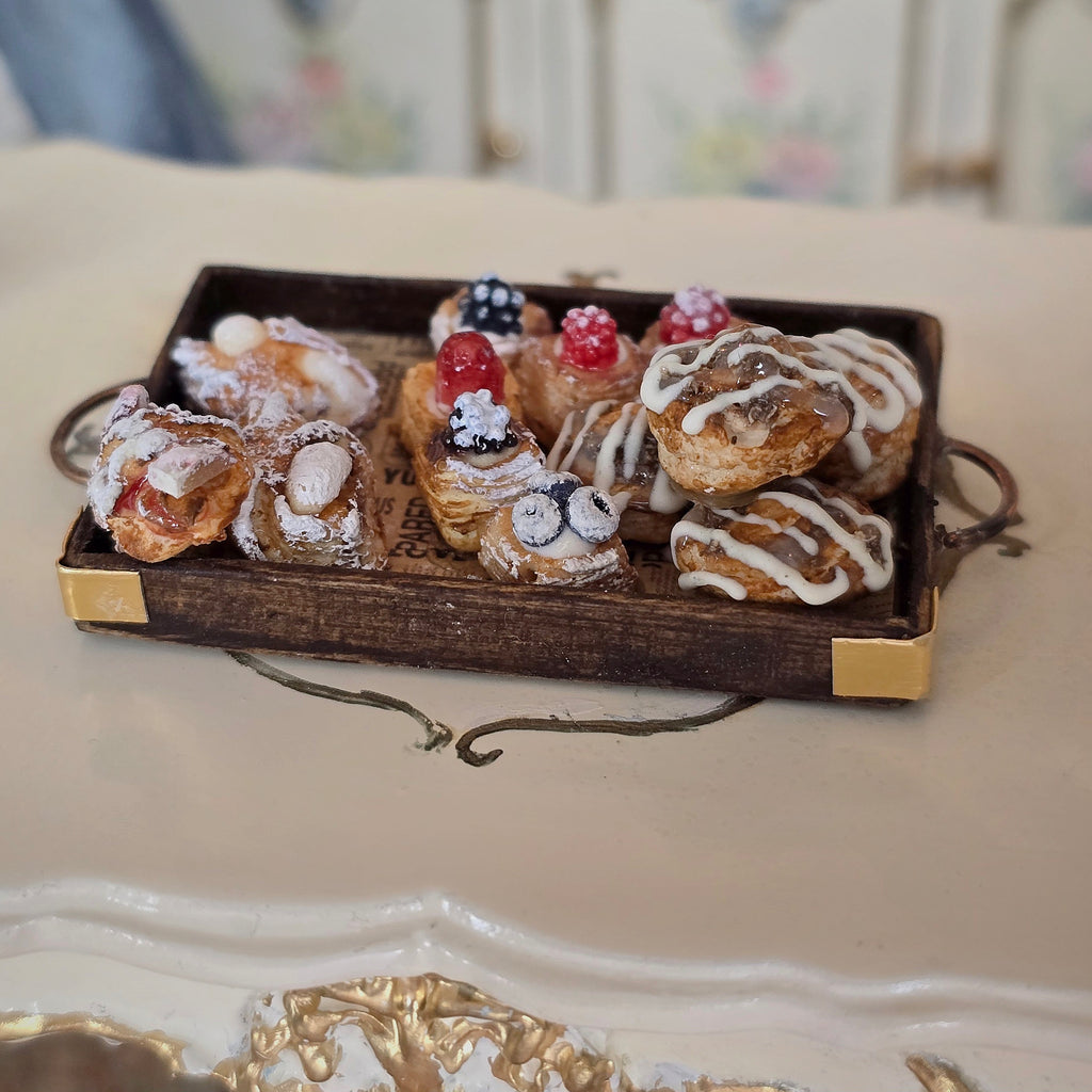 Assorted pastries on a decorative tray with a blurred background