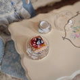 Load image into Gallery viewer, Miniature pastry with jam and berries on a decorative background.
