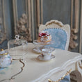 Load image into Gallery viewer, pastry on cake stand on a decorative table in an elegant room.
