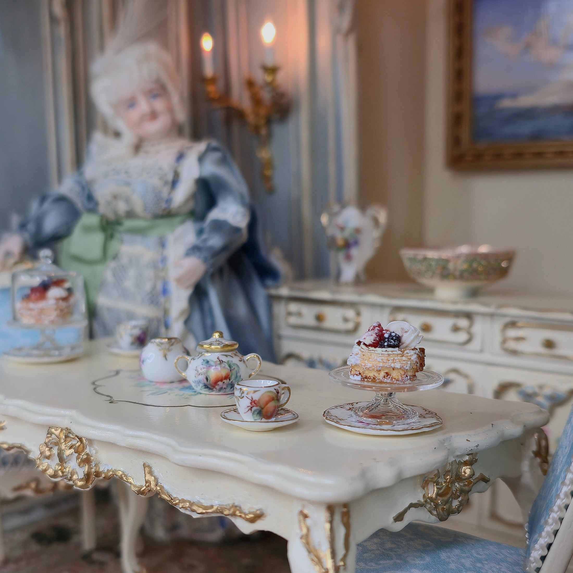 Vintage doll in a decorative dining room with a pastry on a cake stand