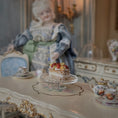 Load image into Gallery viewer, Miniature doll in a vintage setting with a pastry on a table
