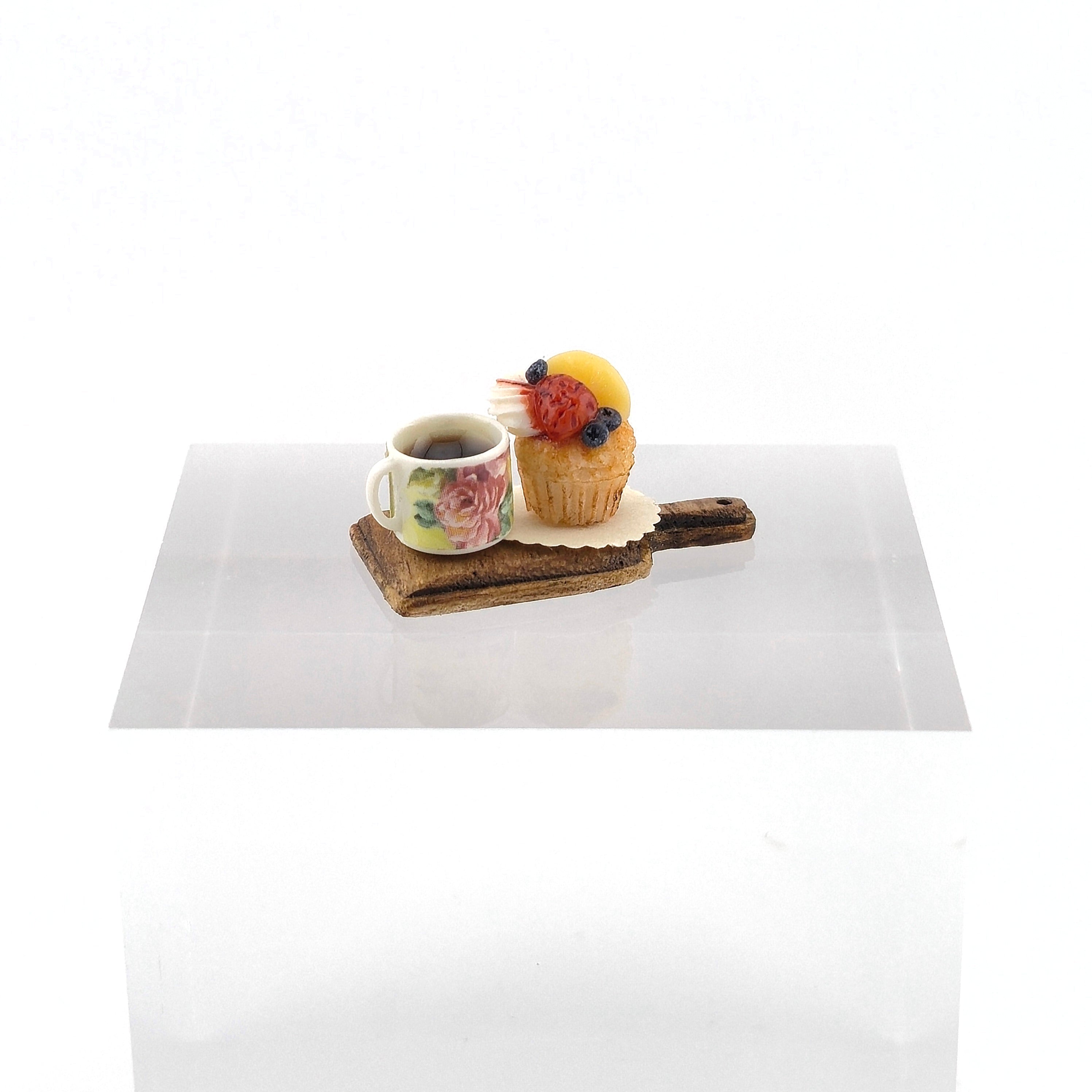 Cup of tea with a pastry on a white surface