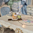 Load image into Gallery viewer, Tea cup and cupcake on a decorative table with a blurred background
