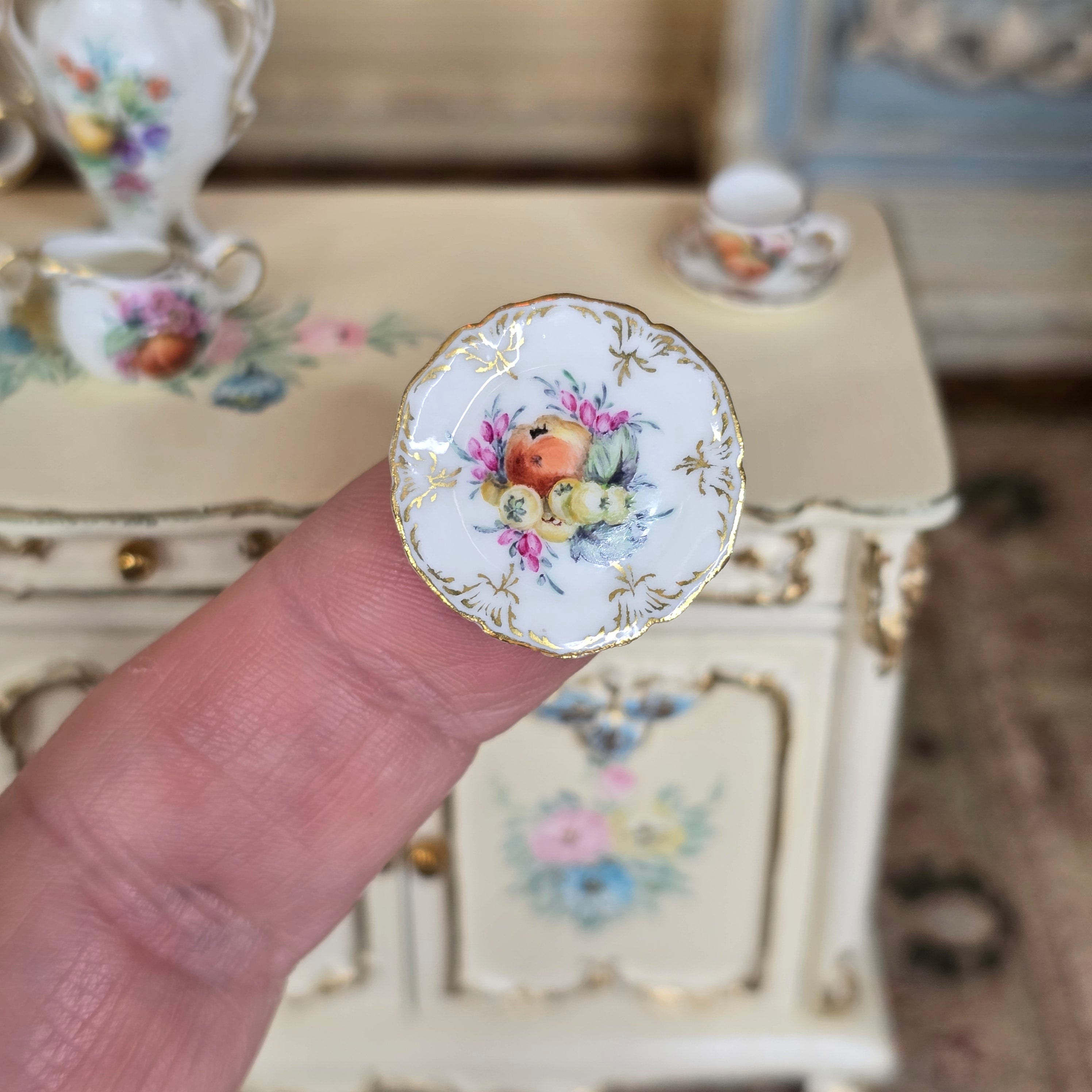 Hand painted Miyuki Nagashima porcelain plate detail, on finger