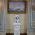 Load image into Gallery viewer, Decorative vase on a pedestal in an ornate room with a painting in the background
