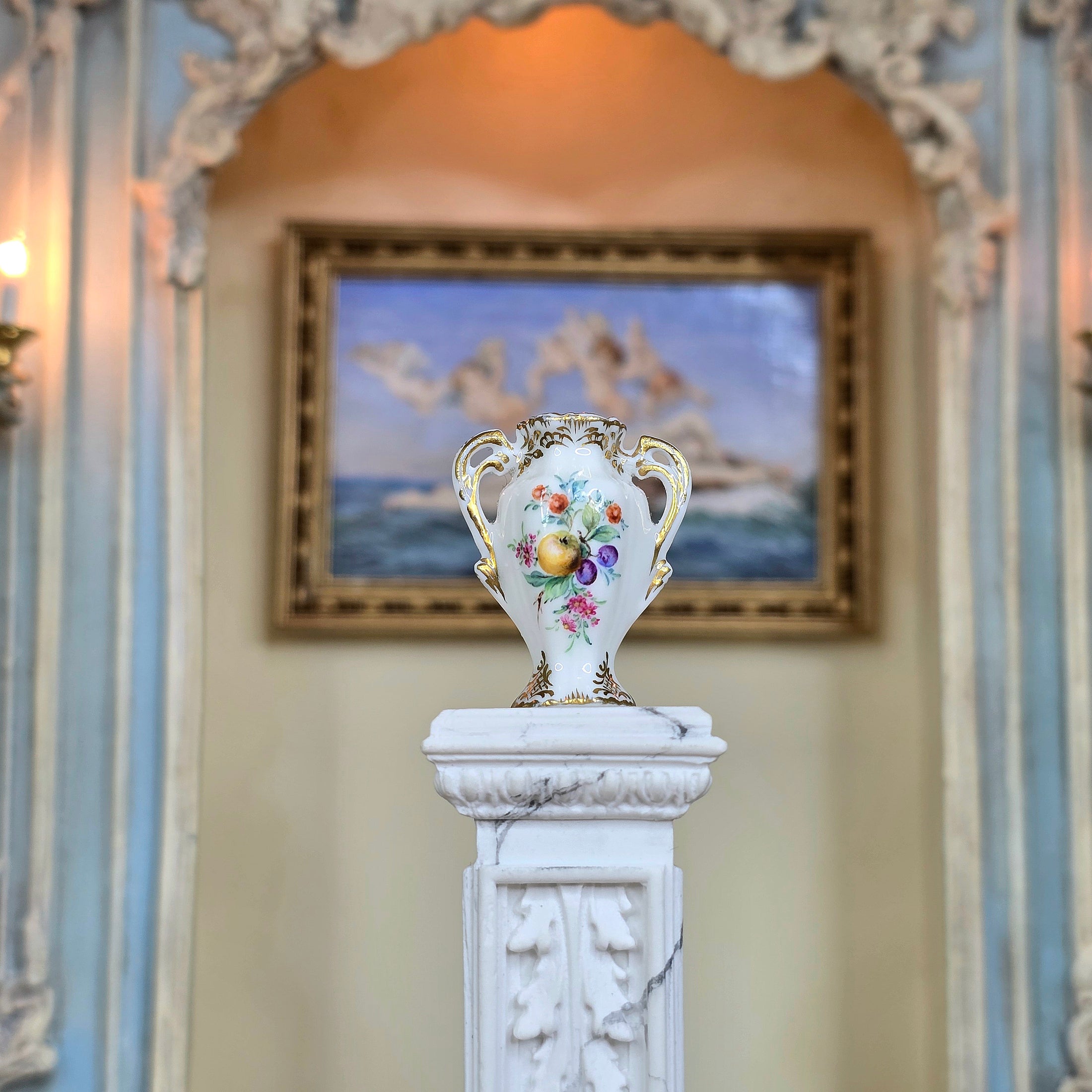 Decorative vase on a pedestal with a classical painting in the background