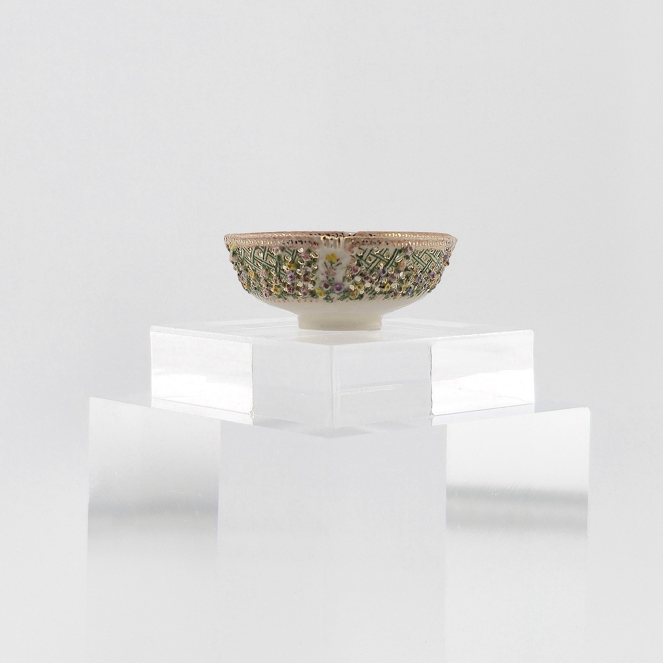 Decorative porcelain bowl with intricate patterns on a white background