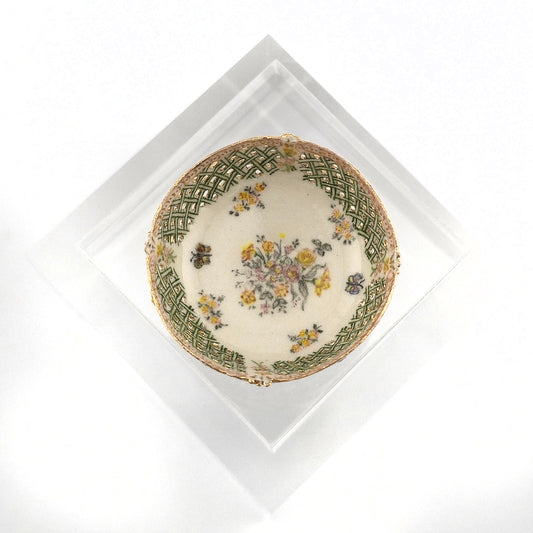 Decorative porcelain bowl with floral design on a white background