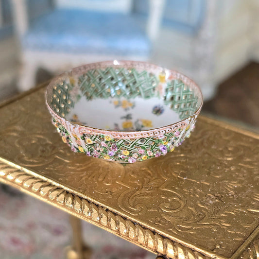 Decorative bowl with intricate patterns on a gold table