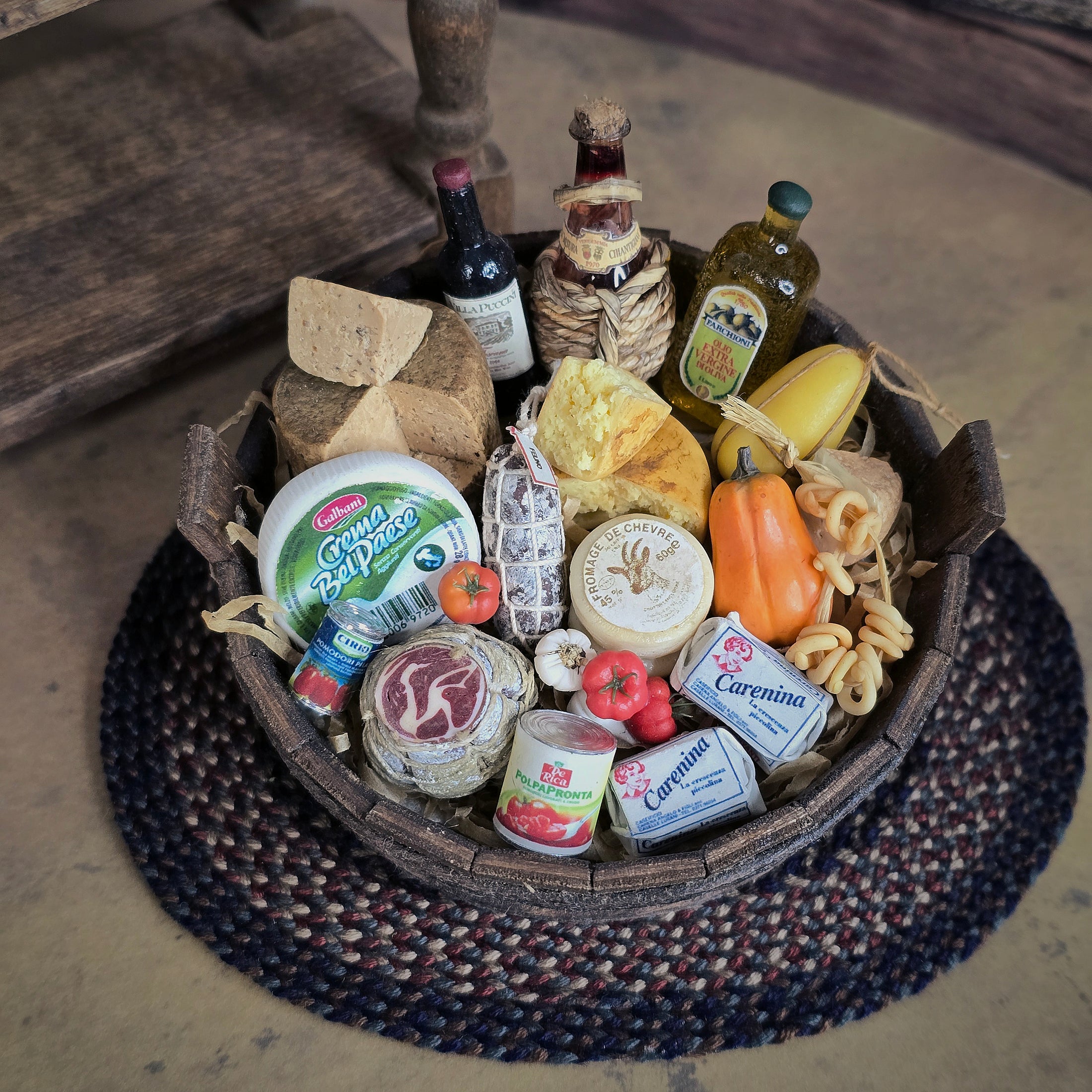 wood basket filled with various food items including cheeses, meats, and bottles 