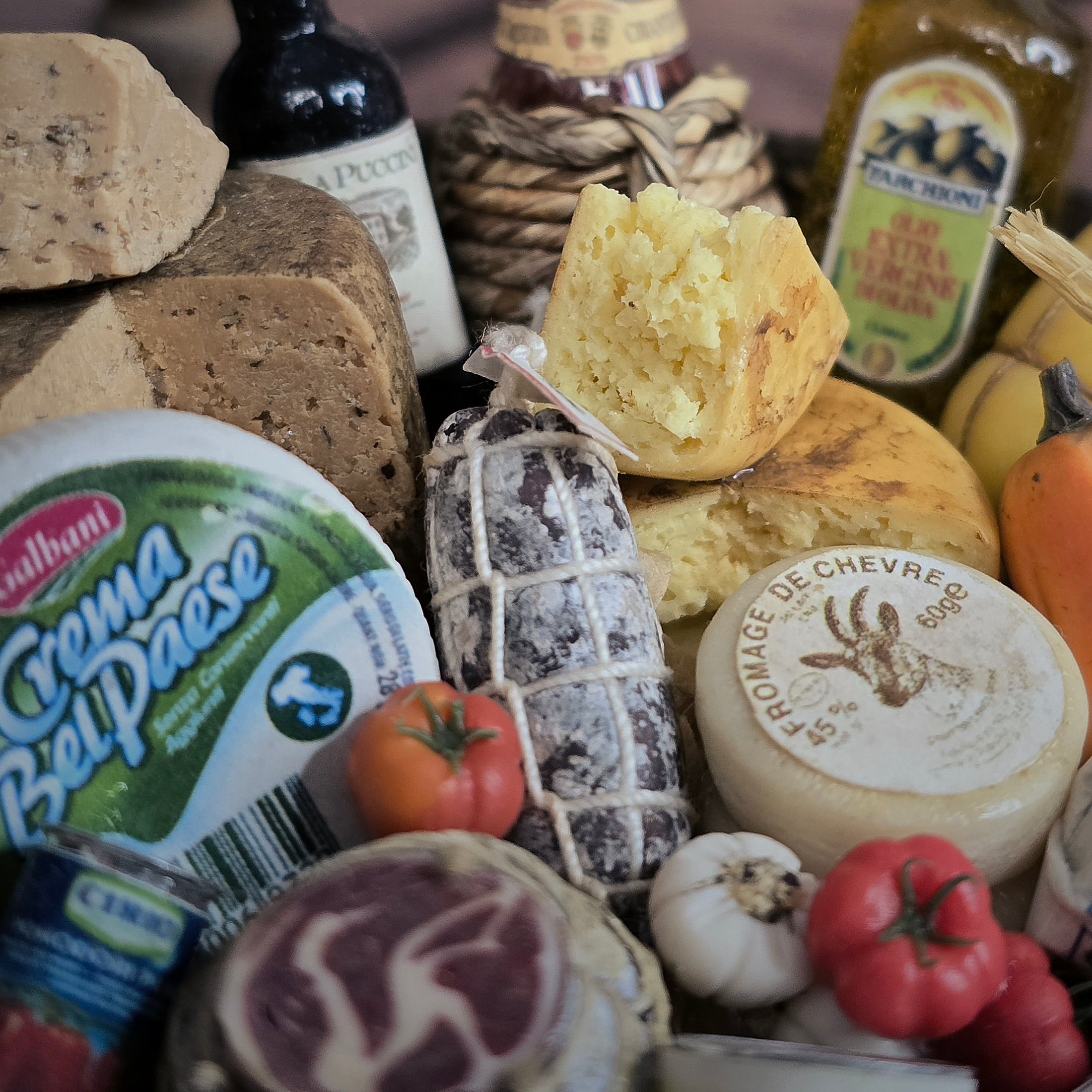 Assorted cheeses, meats, and condiments on a wooden board with a blurred background.