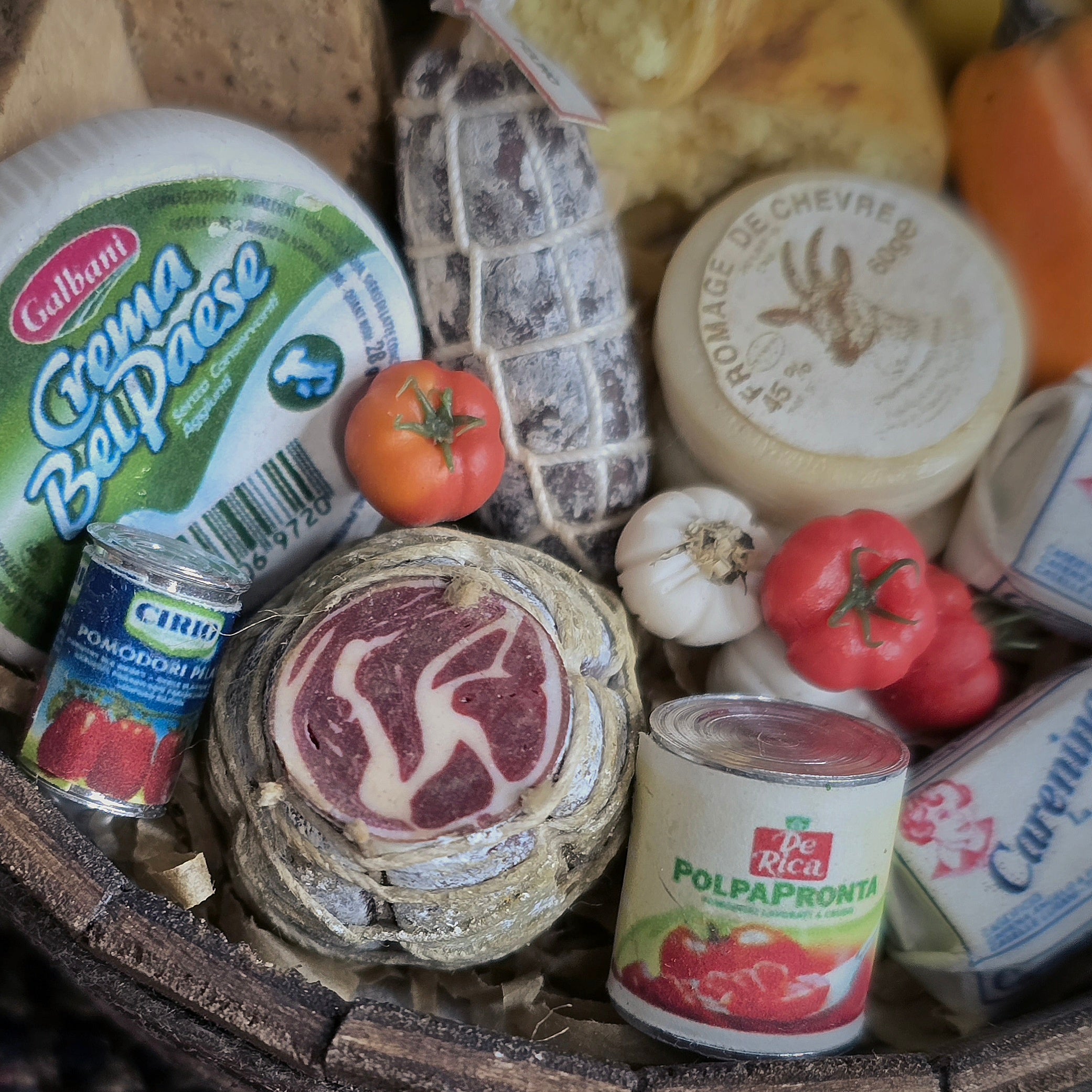 Assorted cheeses, meats, and canned goods in a wooden basket