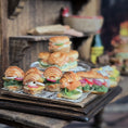 Load image into Gallery viewer, Miniature croissants sandwiches on a wooden stand with blurred background
