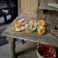 Load image into Gallery viewer, Miniature food items on a wooden table with a rustic background
