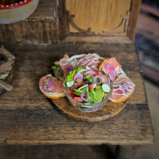 Miniature salad with bread and toppings on a wooden table