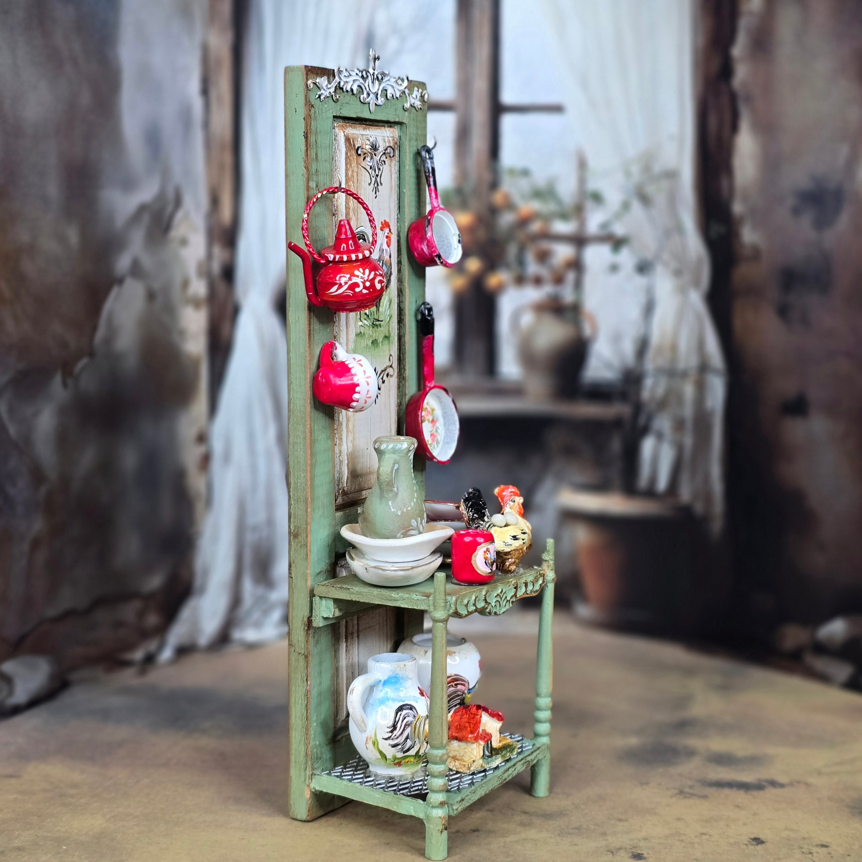 Miniature green shelf with decorative items against a blurred indoor background