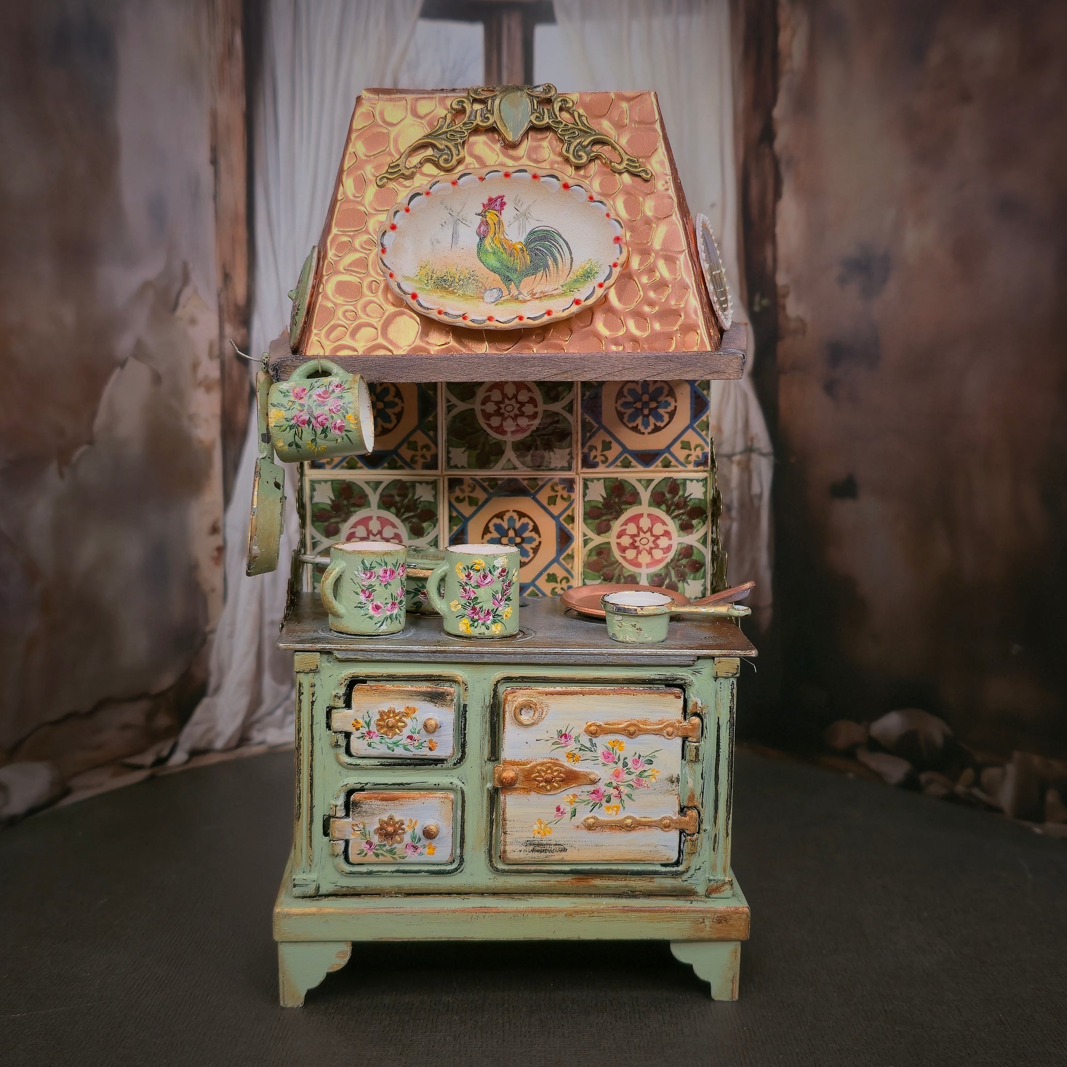 Decorative kitchen stove with floral and rooster designs against a curtain backdrop