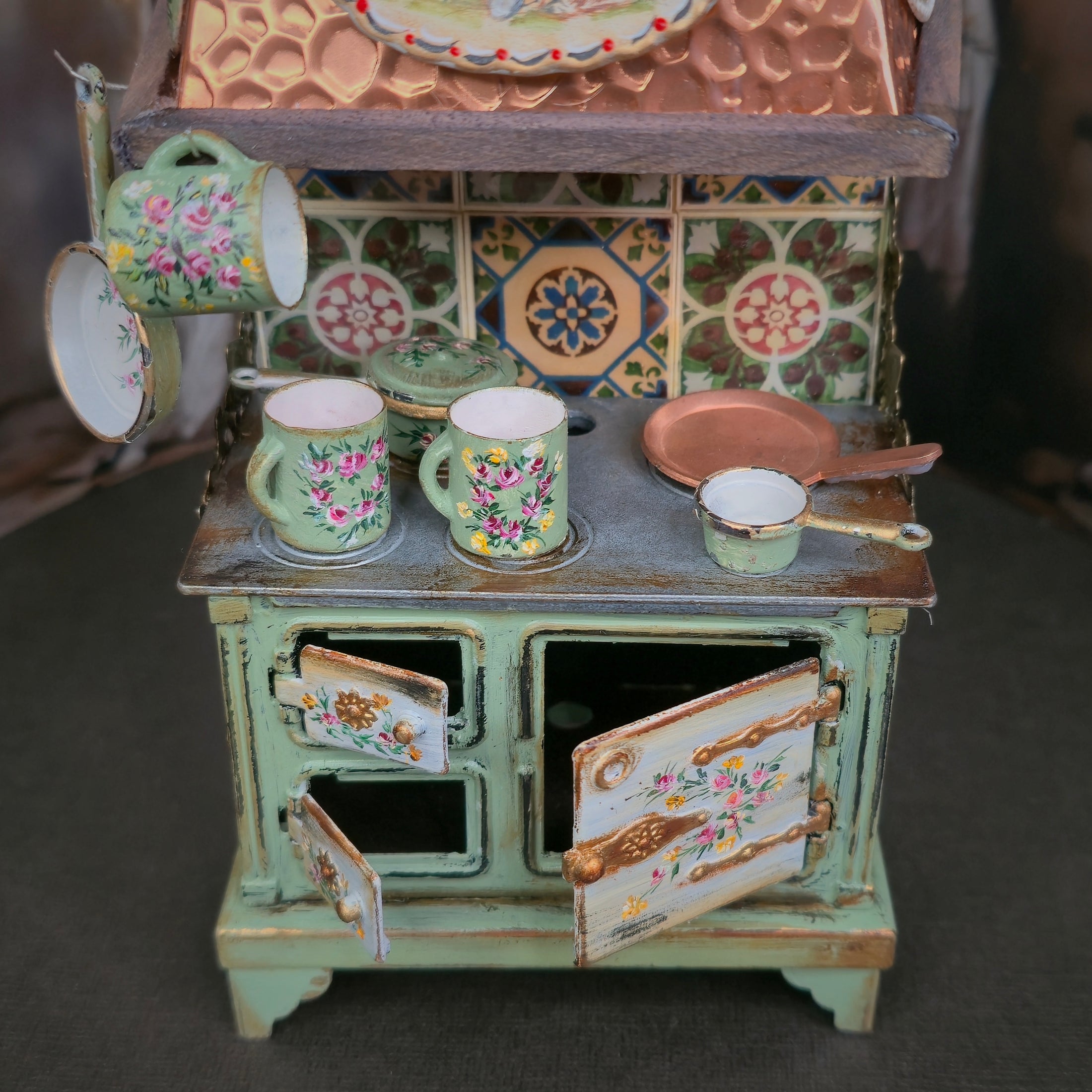 Miniature dollhouse kitchen stove on a dark background