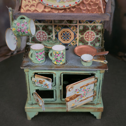Miniature dollhouse kitchen stove on a dark background
