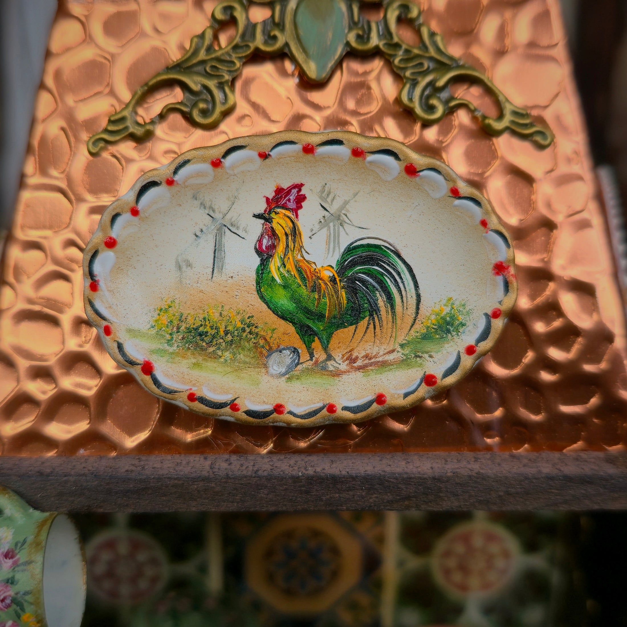 Decorative plate with a rooster design on a textured surface