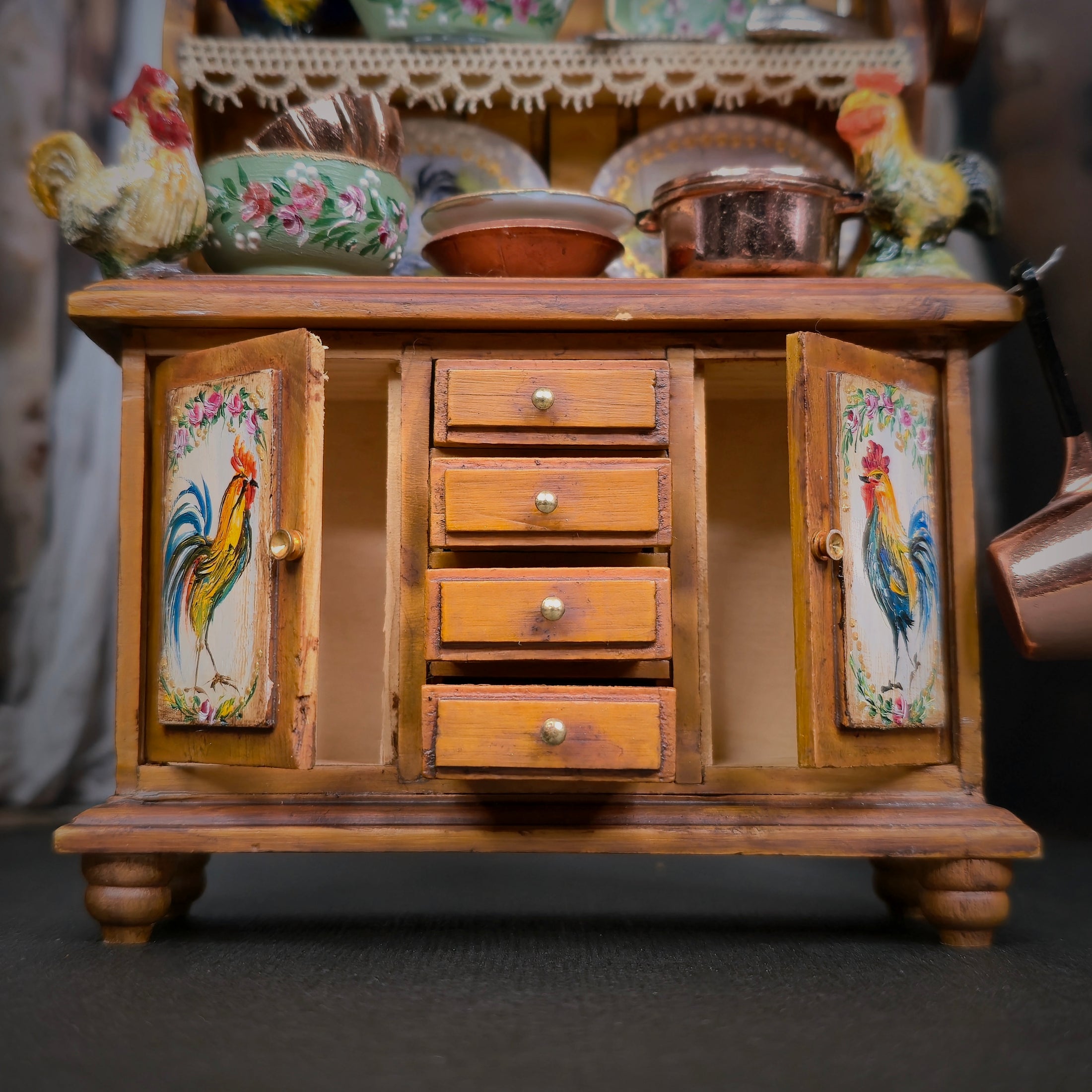 Wooden sideboard with rooster decorations on a dark background