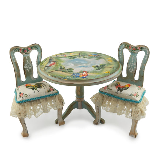 Decorative miniature table and chairs with rooster designs on a white background