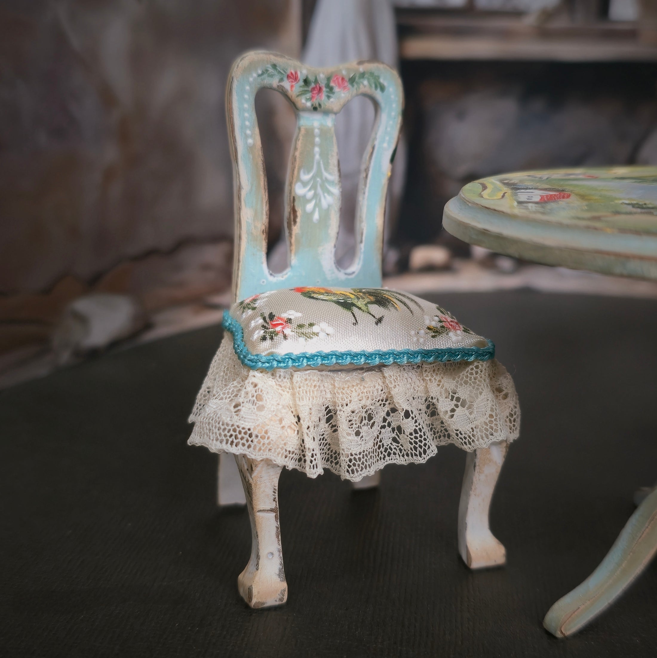Vintage-style chair with floral patterns and lace skirt in a softly blurred background