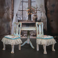 Load image into Gallery viewer, Two ornate chairs with lace cushions in a softly blurred room setting.
