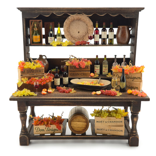 Wine-themed display with bottles, fruits, and decorative items on a wooden shelf.