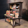 Load image into Gallery viewer, Wooden bar setup with bottles, glasses, and decorative elements on a dark background
