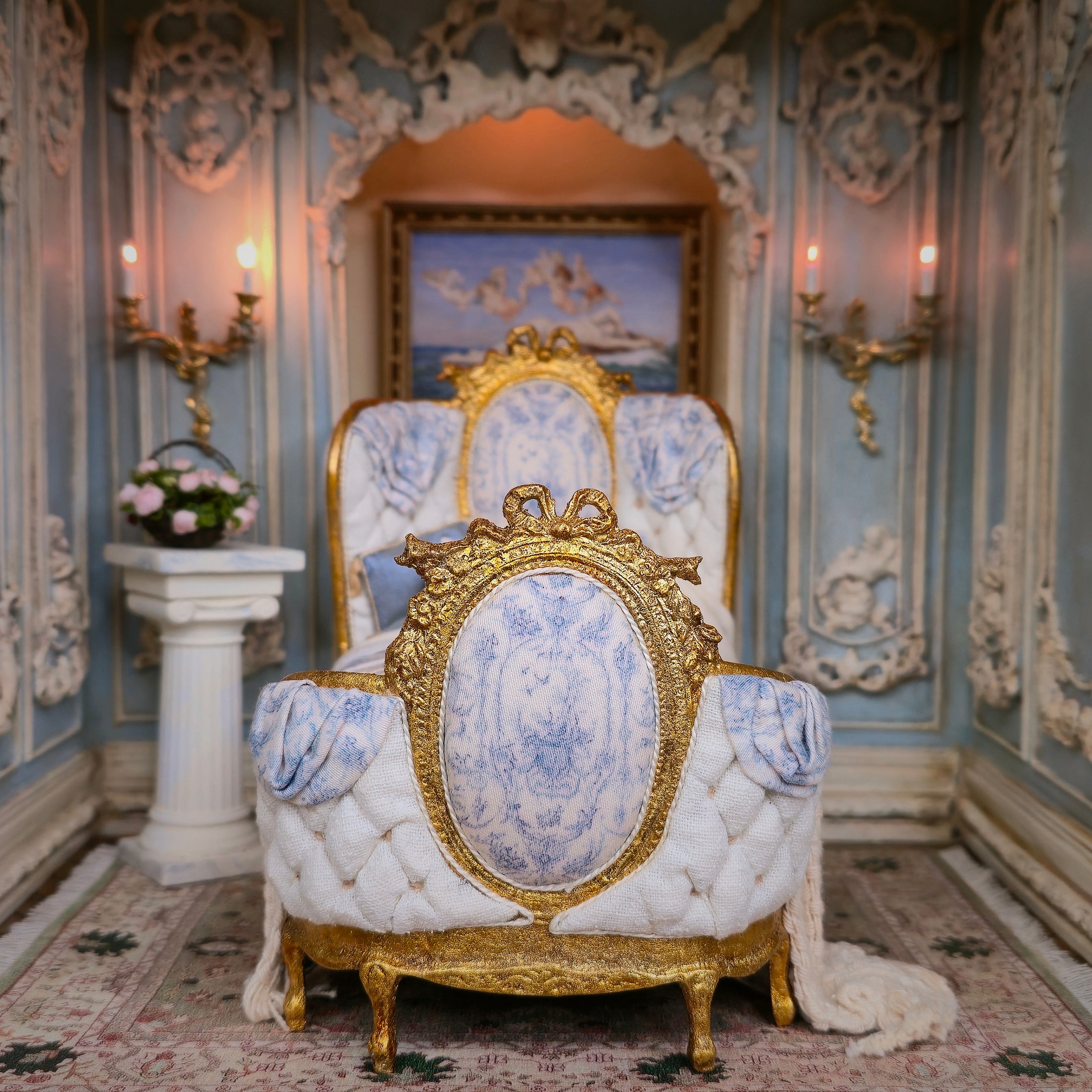 Opulent bed footboard with gold and white detailing in a decorative room.