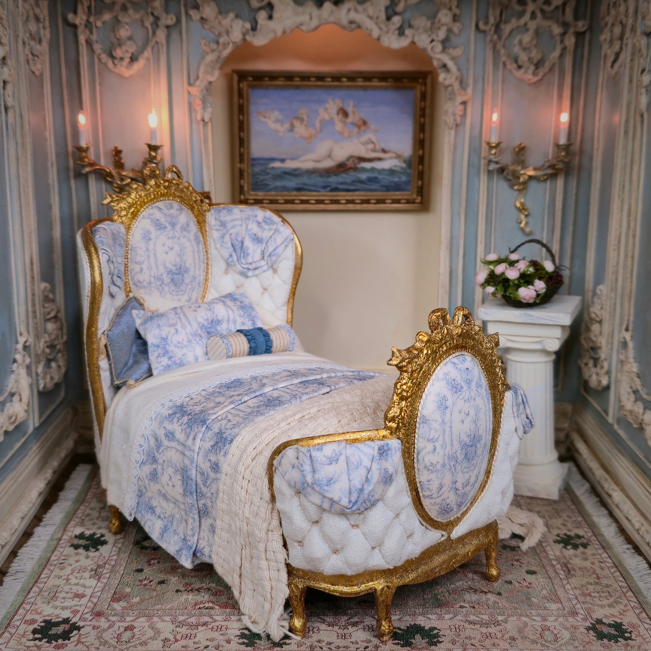 Decorative bed with gold accents and blue patterned fabric in an ornate room.