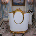 Load image into Gallery viewer, back of bed with gold accents in an ornate room.

