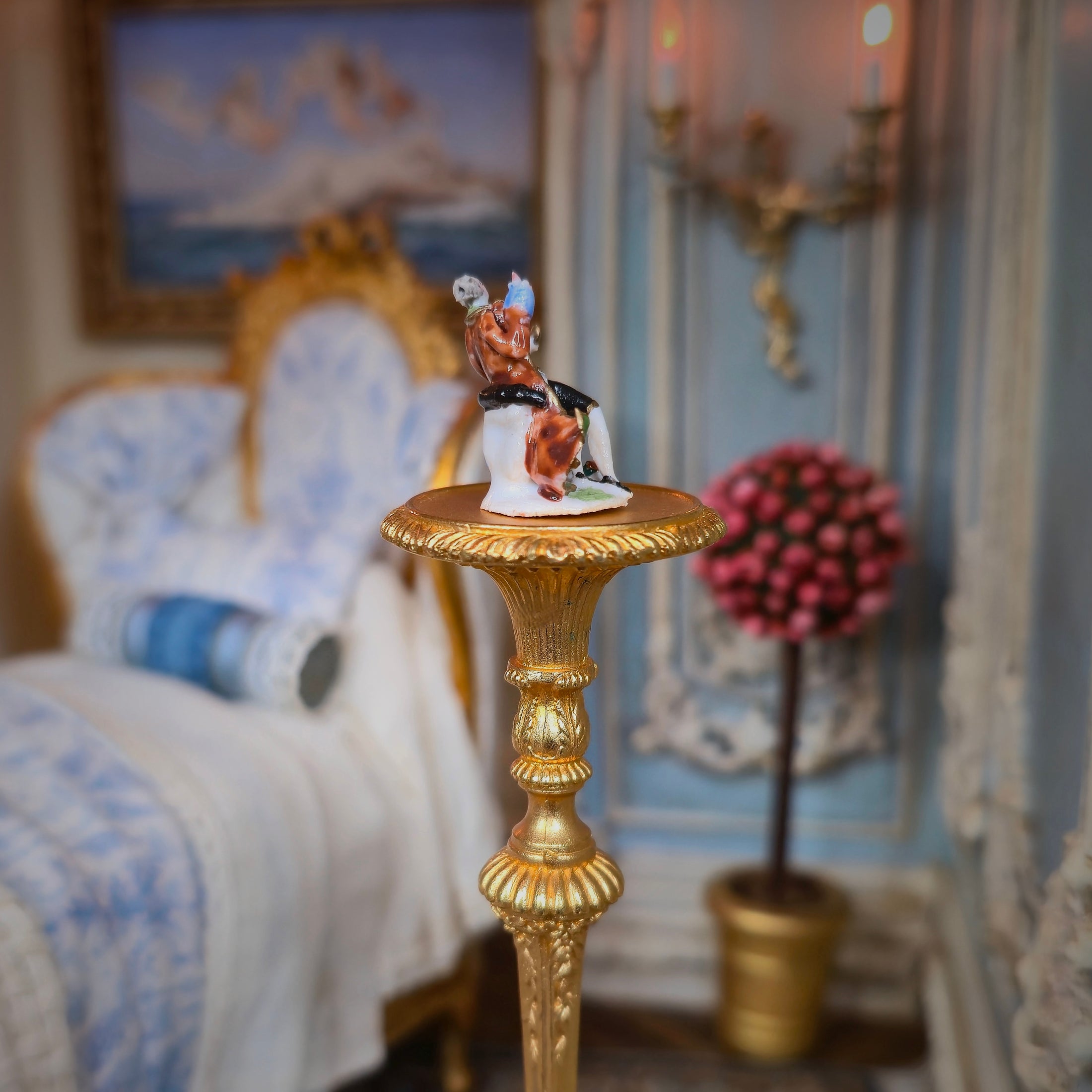 Decorative figurine on a gold pedestal in an ornate room with furniture and decor.